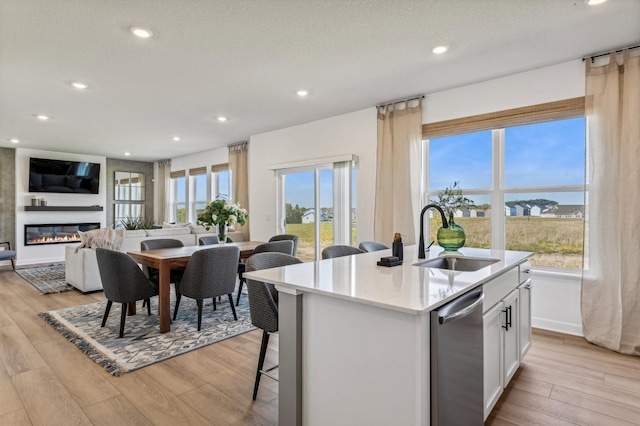 7588 Norway Ln, Lino Lakes, MN 55038 - kitchen with dishwasher, light countertops, a center island with sink, light wood finished floors, and recessed lighting