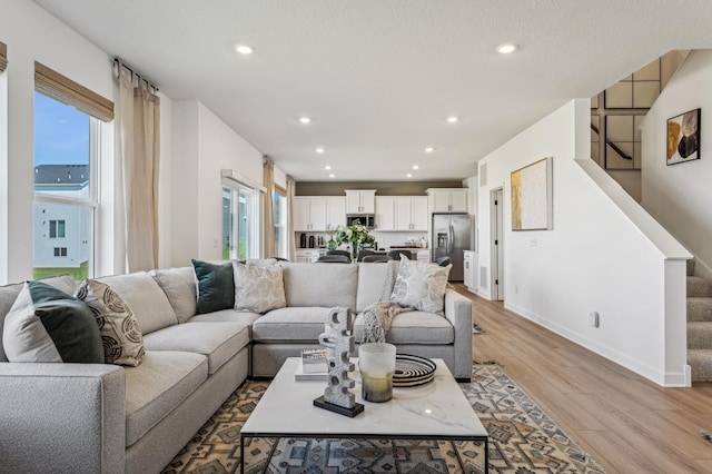 7588 Norway Ln, Lino Lakes, MN 55038 - living room featuring stairs, light wood finished floors, and recessed lighting