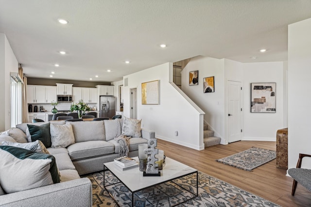 7588 Norway Ln, Lino Lakes, MN 55038 - living area featuring stairs, light wood-style flooring, and recessed lighting