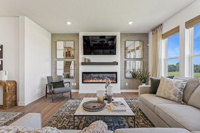7588 Norway Ln, Lino Lakes, MN 55038 - living room with wood finished floors, a glass covered fireplace, and recessed lighting