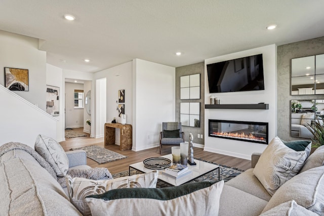7588 Norway Ln, Lino Lakes, MN 55038 - living room featuring wood finished floors, recessed lighting, and a glass covered fireplace