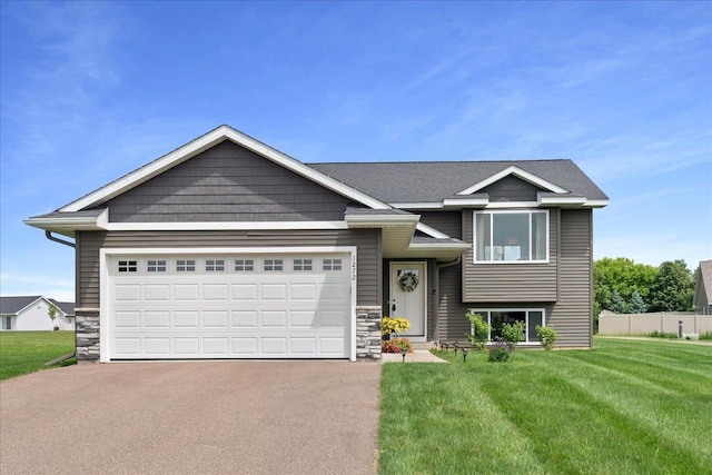 1272 Pheasant Run, New Richmond, WI 54017 - view of front facade with asphalt driveway, stone siding, and a garage