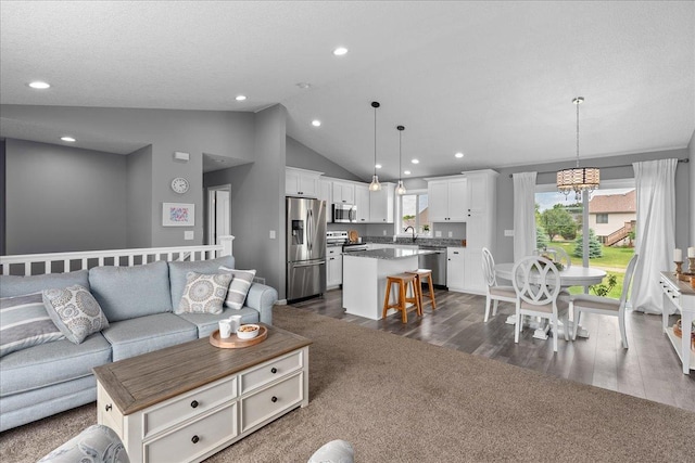 1272 Pheasant Run, New Richmond, WI 54017 - living room with dark wood-type flooring, vaulted ceiling, a chandelier, and recessed lighting
