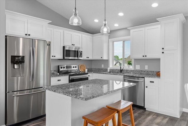 1272 Pheasant Run, New Richmond, WI 54017 - kitchen with stainless steel appliances, lofted ceiling, white cabinets, dark wood finished floors, and a center island