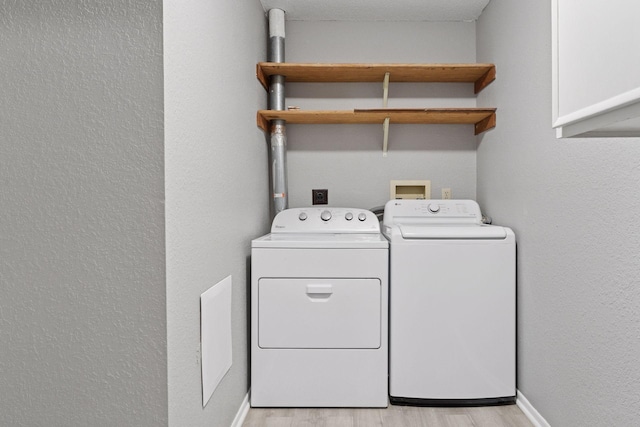 1573 Cohansey St Unit 205, Saint Paul, MN 55117 - laundry area with washing machine and clothes dryer, light wood-style floors, and a textured wall