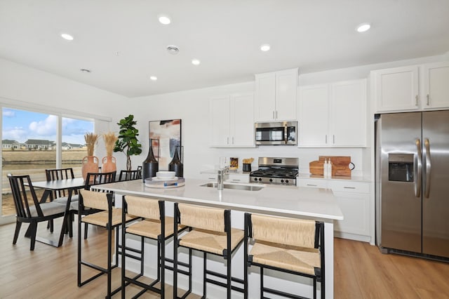 6265 205th St N, Forest Lake, MN 55025 - kitchen with appliances with stainless steel finishes, light wood-style flooring, light countertops, a center island with sink, and recessed lighting