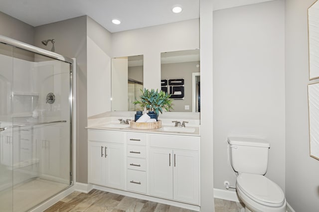 6265 205th St N, Forest Lake, MN 55025 - bathroom featuring a stall shower, double vanity, wood finished floors, and recessed lighting