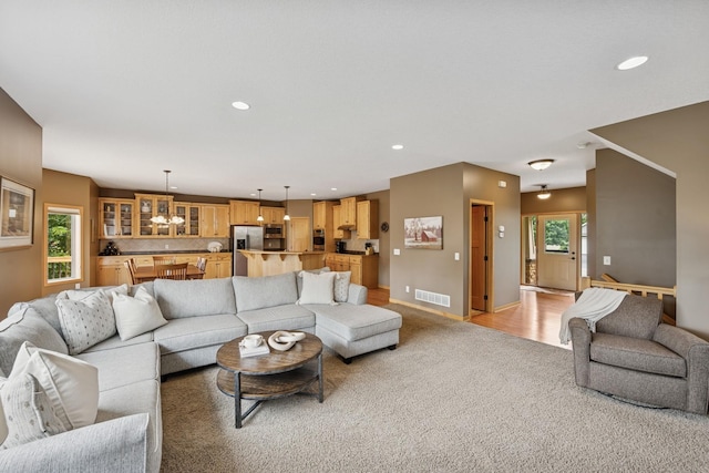 15807 Martin St NW, Andover, MN 55304 - living room with light carpet, a chandelier, and recessed lighting