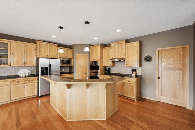 15807 Martin St NW, Andover, MN 55304 - kitchen featuring stainless steel appliances, light brown cabinets, under cabinet range hood, backsplash, and recessed lighting