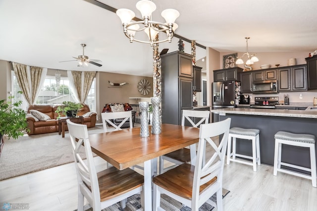 4450 48th St S, Fargo, ND 58104 - dining space with a chandelier, vaulted ceiling, light wood finished floors, and ceiling fan