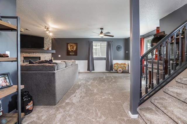 4450 48th St S, Fargo, ND 58104 - living room featuring stairs, ceiling fan, carpet floors, a textured ceiling, and a fireplace