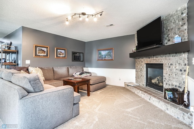 4450 48th St S, Fargo, ND 58104 - carpeted living area featuring a fireplace and a textured ceiling