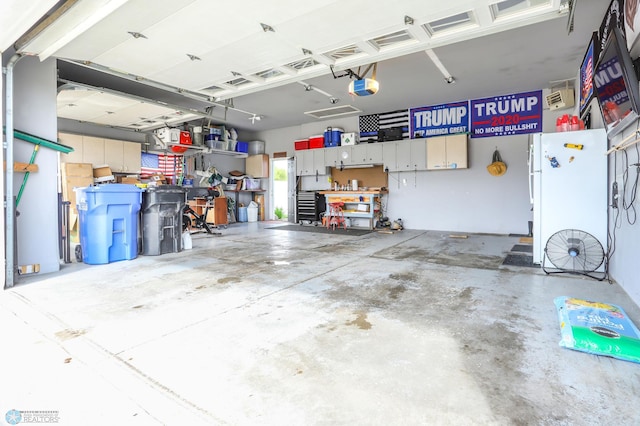 4450 48th St S, Fargo, ND 58104 - garage featuring a garage door opener and freestanding refrigerator