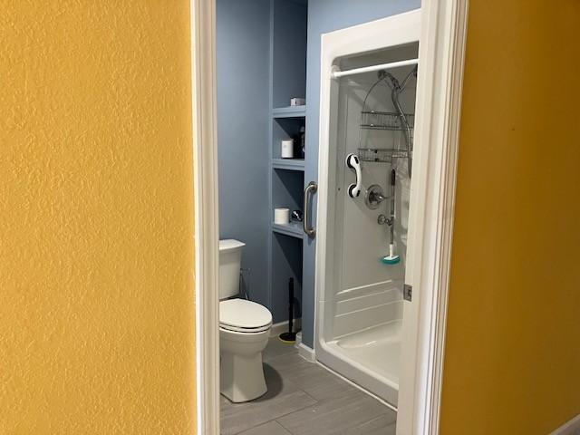 34358 State Highway 18, Finlayson Twp, MN 55735 - full bathroom with a stall shower, a textured wall, and tile patterned floors