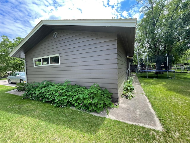 546 6th St S, Greenbush, MN 56726 - view of home's exterior with a trampoline and a yard