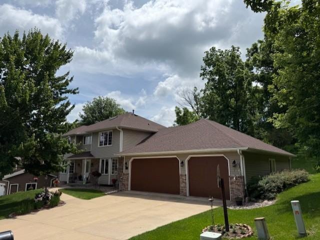 85 Forest Oak Ct, Winona, MN 55987 - view of front of home featuring a garage, driveway, and a front lawn