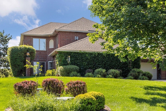 1900 Hunter Hill Rd, Hudson, WI 54016 - view of front of home with brick siding, a front yard, roof with shingles, and an attached garage