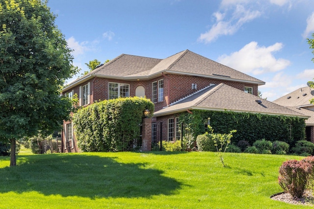 1900 Hunter Hill Rd, Hudson, WI 54016 - view of home's exterior with brick siding, a lawn, and roof with shingles