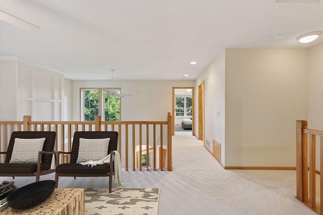1900 Hunter Hill Rd, Hudson, WI 54016 - living area featuring an upstairs landing, light carpet, and recessed lighting