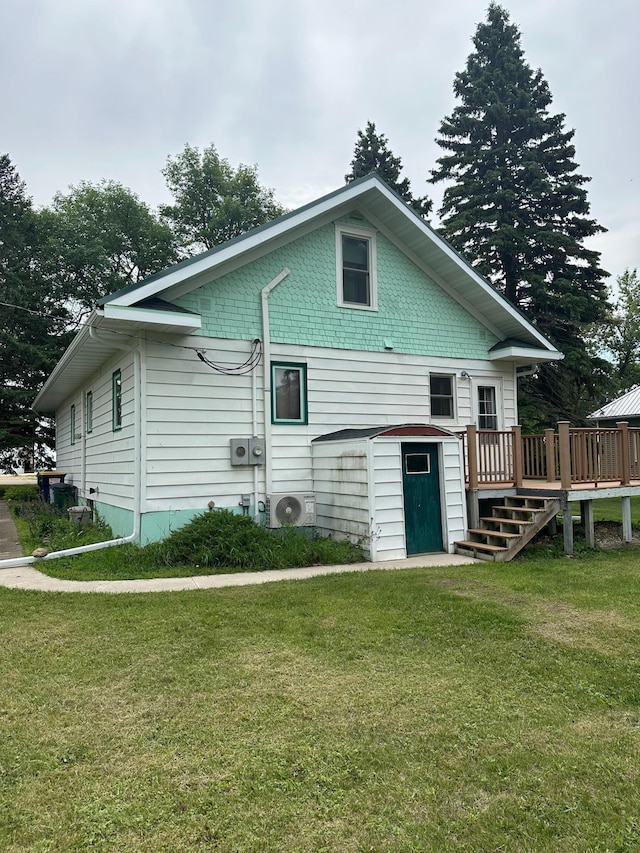 220 Woodman Ave, Dovray, MN 56125 - back of house featuring a wooden deck and a lawn