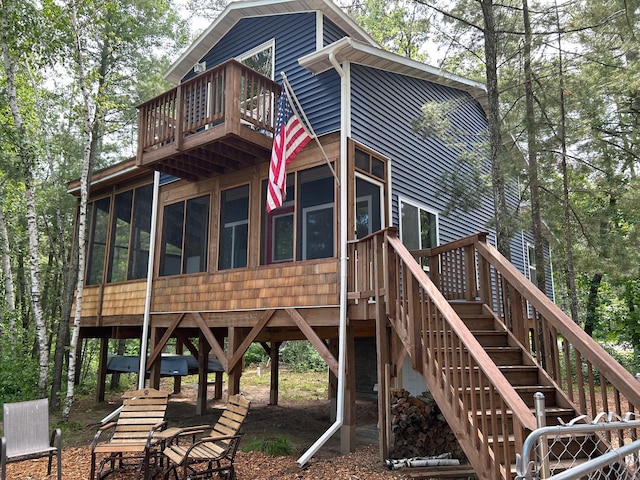 6274 Azalea Rd, Motley Twp, MN 56466 - back of house with a sunroom, a balcony, and stairway