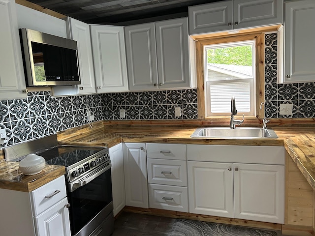 6274 Azalea Rd, Motley Twp, MN 56466 - kitchen with wood counters, appliances with stainless steel finishes, white cabinets, and backsplash
