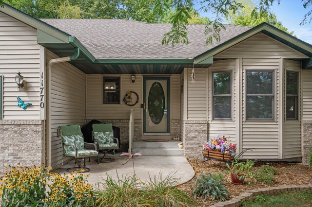 11770 N Meadow Curv, Lindstrom, MN 55045 - doorway to property with brick siding and roof with shingles