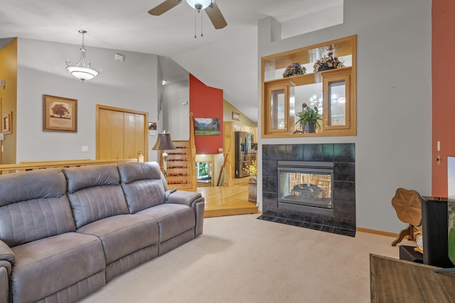 11770 N Meadow Curv, Lindstrom, MN 55045 - living area featuring carpet flooring, vaulted ceiling, a ceiling fan, a fireplace, and stairs