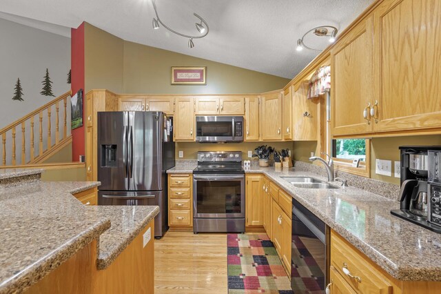 11770 N Meadow Curv, Lindstrom, MN 55045 - kitchen with stainless steel appliances, vaulted ceiling, light wood-type flooring, light stone counters, and light brown cabinets