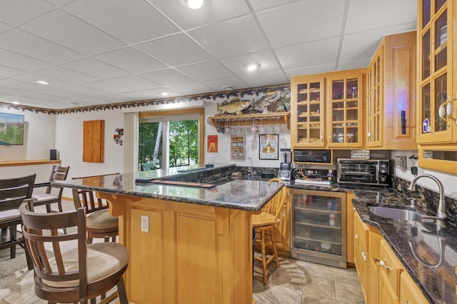 11770 N Meadow Curv, Lindstrom, MN 55045 - kitchen featuring wine cooler, a breakfast bar area, dark stone countertops, glass insert cabinets, and a drop ceiling