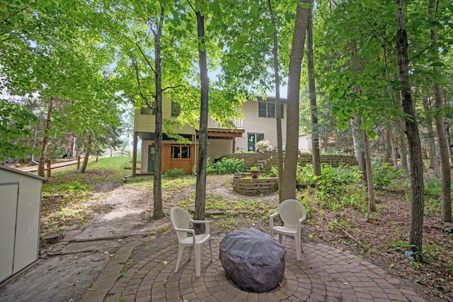 11770 N Meadow Curv, Lindstrom, MN 55045 - view of patio featuring an outdoor fire pit and an outdoor structure