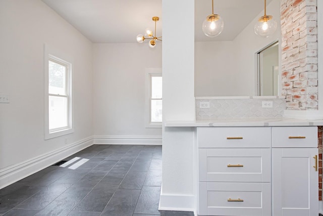 322 Jefferson St, Caledonia, MN 55921 - bathroom with vanity, a chandelier, and backsplash