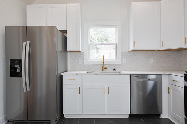 322 Jefferson St, Caledonia, MN 55921 - kitchen featuring appliances with stainless steel finishes, white cabinets, light countertops, and decorative backsplash