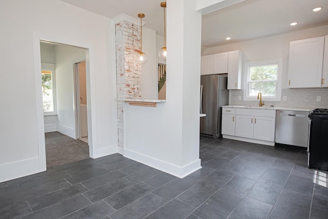 322 Jefferson St, Caledonia, MN 55921 - kitchen featuring stainless steel appliances, white cabinetry, light countertops, backsplash, and recessed lighting