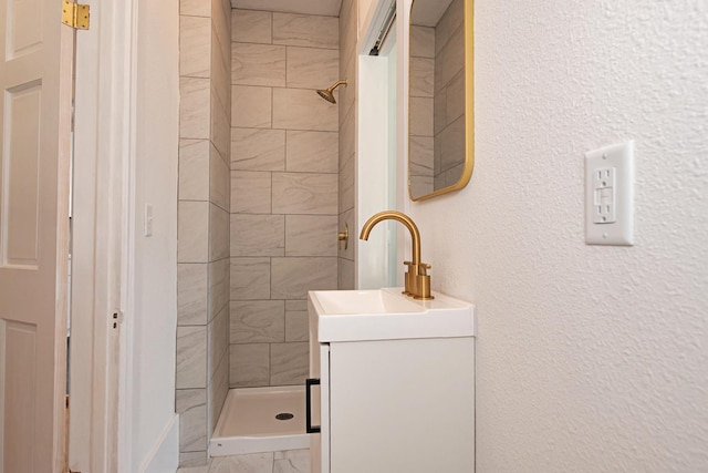 322 Jefferson St, Caledonia, MN 55921 - bathroom with a stall shower, vanity, marble look tiles, and a textured wall