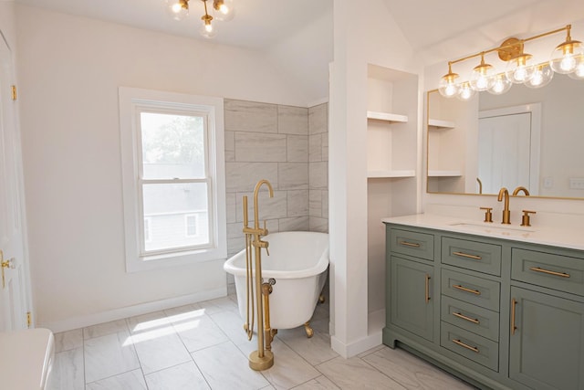 322 Jefferson St, Caledonia, MN 55921 - full bath featuring lofted ceiling, a freestanding bath, vanity, marble finish flooring, and a chandelier