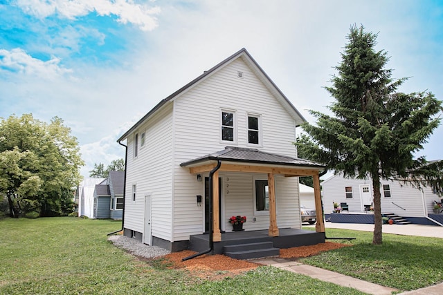 322 Jefferson St, Caledonia, MN 55921 - view of front facade featuring a porch, a front lawn, a metal roof, and a standing seam roof