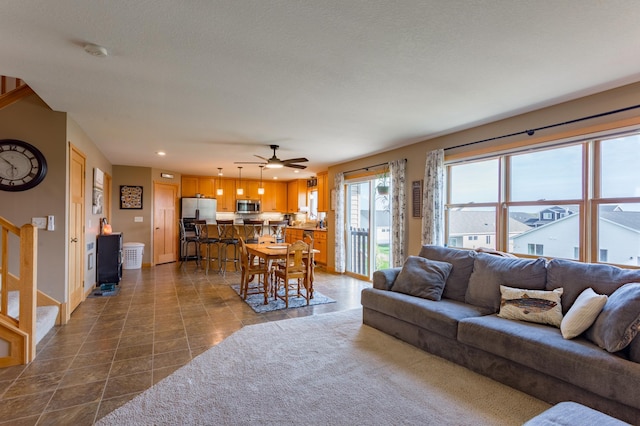 104 Sylla St, River Falls, WI 54022 - living area with recessed lighting, a ceiling fan, stairway, and dark tile patterned floors