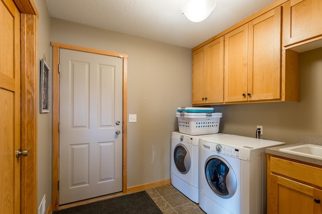 104 Sylla St, River Falls, WI 54022 - washroom with cabinet space, washer and clothes dryer, and dark tile patterned floors