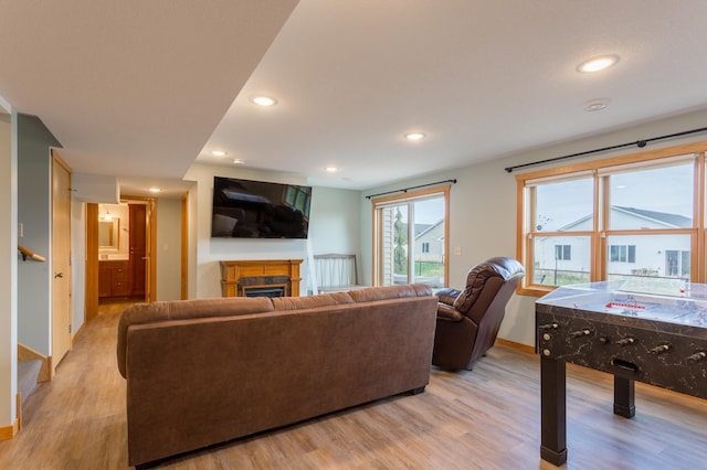 104 Sylla St, River Falls, WI 54022 - living area with light wood-type flooring, a fireplace, recessed lighting, and stairs