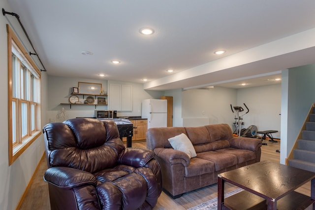 104 Sylla St, River Falls, WI 54022 - living room featuring light wood-style floors, stairway, and recessed lighting