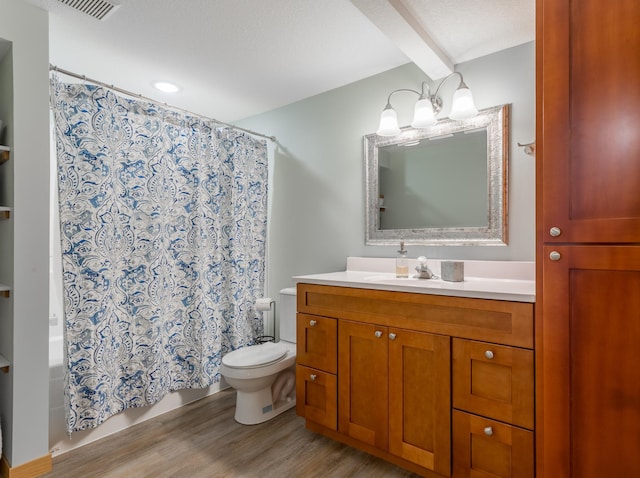 104 Sylla St, River Falls, WI 54022 - full bathroom with wood finished floors, vanity, shower / tub combo, and beamed ceiling