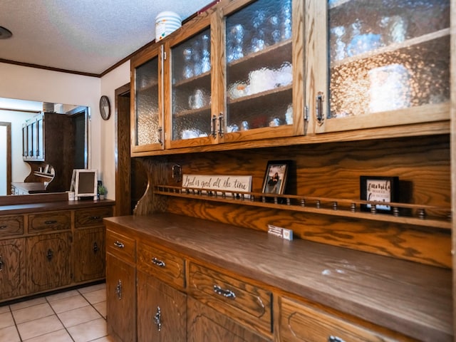 8585 Ilex Pl NW, Rice, MN 56367 - bar area featuring crown molding, light tile patterned floors, and a textured ceiling