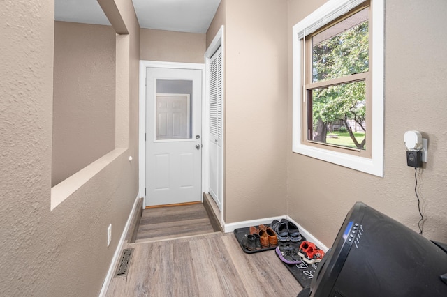 111 4th St N, Grove City, MN 56243 - doorway to outside featuring wood finished floors and baseboards