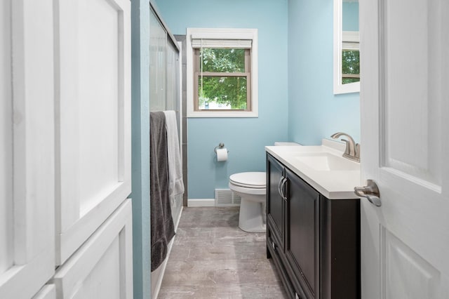 111 4th St N, Grove City, MN 56243 - bathroom with vanity, a shower with shower curtain, and wood finished floors