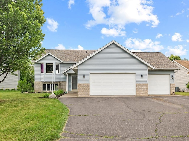 6735 378th St, North Branch, MN 55056 - view of front of house with brick siding, asphalt driveway, an attached garage, a front lawn, and a shingled roof