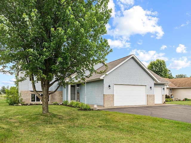 6735 378th St, North Branch, MN 55056 - view of front facade with a garage, brick siding, driveway, and a front yard