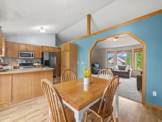 6735 378th St, North Branch, MN 55056 - dining space with vaulted ceiling, light wood finished floors, and arched walkways