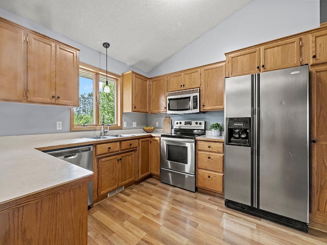6735 378th St, North Branch, MN 55056 - kitchen with appliances with stainless steel finishes, lofted ceiling, a textured ceiling, light wood finished floors, and light countertops