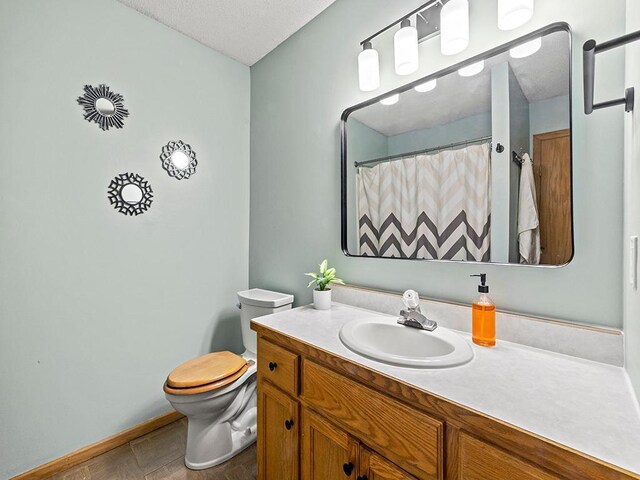 6735 378th St, North Branch, MN 55056 - bathroom featuring vanity, a textured ceiling, and a shower with shower curtain